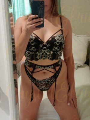 Curvy woman posing in black lingerie